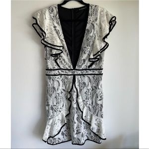 PRETTY LITTLE THING white lace mini dress with deep front V.